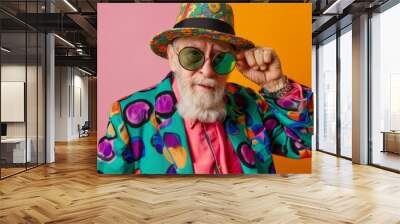 Youthful and stylish senior old man with extravagant clothes and sunglasses. Carefree positive pensioner wear trendy colourful outfit. Youthful senior people and lifestyle concept Wall mural